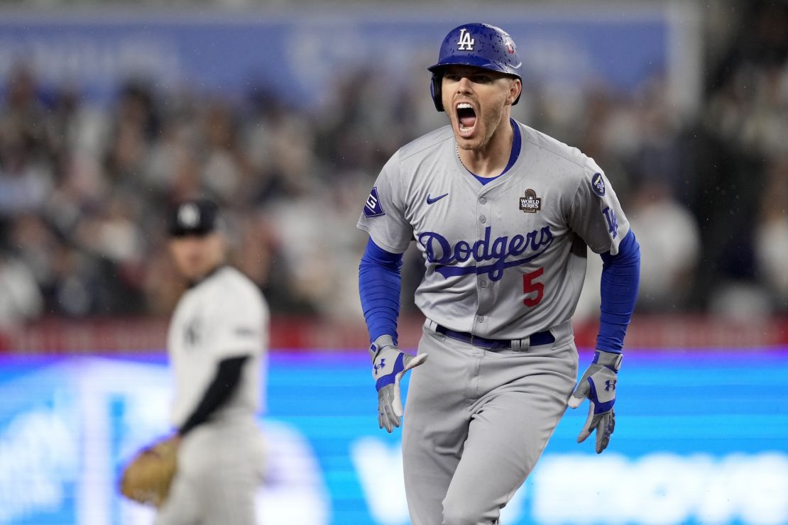 Los Angeles Dodgers' Freddie Freeman hits a home run in a record six consecutive World Series games in first inning.