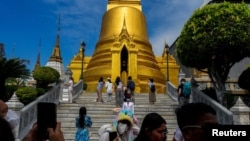 FILE - Tourists visit the Grand Palace, one of Thailand's top tourist attractions, in Bangkok, Jan. 7, 2023.