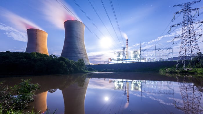 A nuclear power plant with power lines overhead.