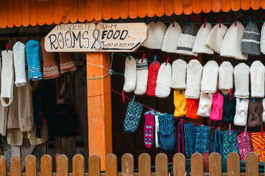 room and food for sale signs in bosnian village with mittens hanging