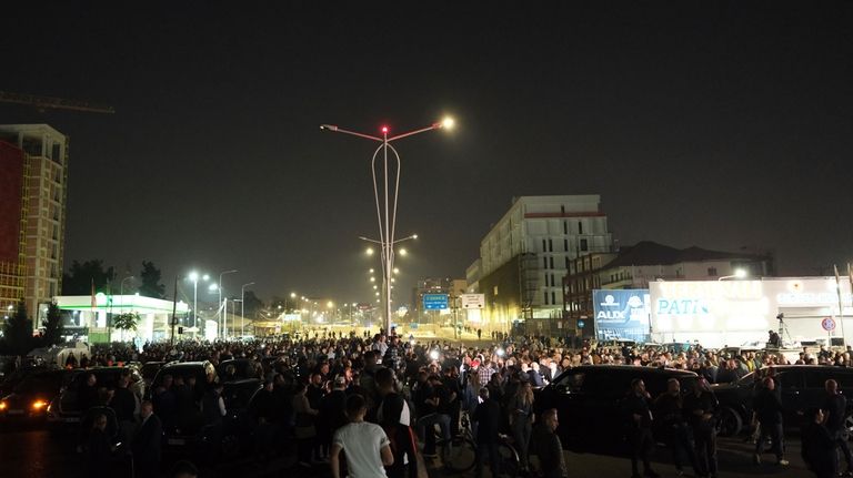 Albanian opposition protesters block a main avenue demanding that the...