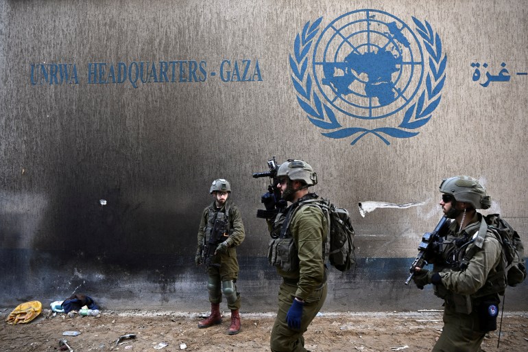 Israeli soldiers operate next to the UNRWA headquarters in the Gaza Strip, February 8, 2024.