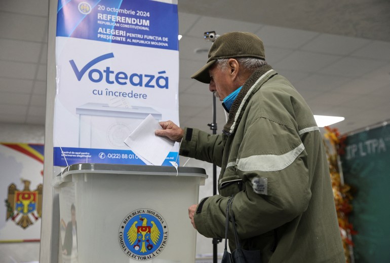 A voter casts a ballot at a polling station, as the country holds a presidential election and a referendum on joining the European Union