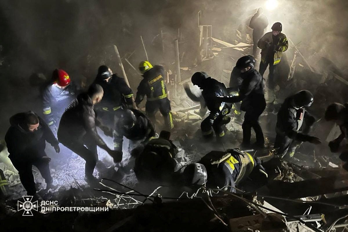 Rescuers work at a site of an apartment building destroyed by a Russian missile strike, amid Russia’s attack on Ukraine, in Dnipro, Ukraine, in this handout picture released 26 October 2024