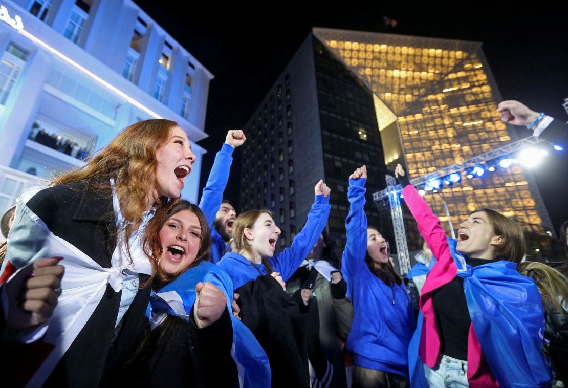 Supporters of the Georgian Dream party celebrate at the party's headquarters after the announcement of exit poll results in Tbilisi on October 26, 2024.