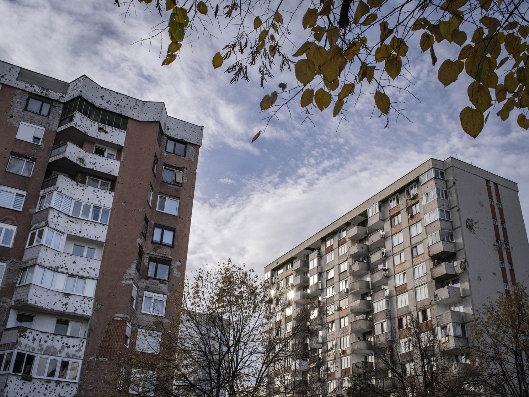 Bullet-riddled buildings on what was once a frontline of the Bosnian civil war, in Sarajevo, Bosnia and Herzegovina. November 3, 2018. (Laura Boushnak/The New York Times)