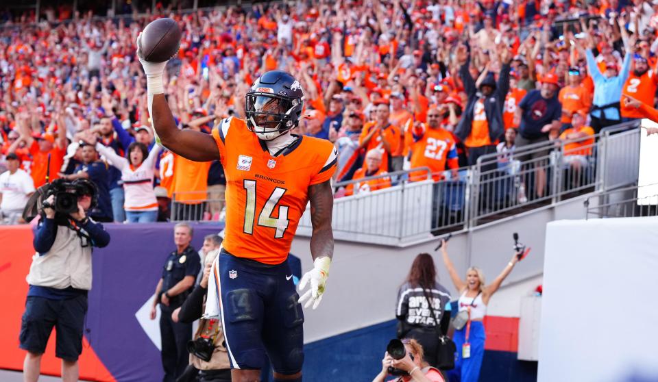 Oct 13, 2024; Denver, Colorado, USA; Denver Broncos wide receiver Courtland Sutton (14) celebrates his touchdown reception in the second half against the Los Angeles Chargers at Empower Field at Mile High. Mandatory Credit: Ron Chenoy-Imagn Images