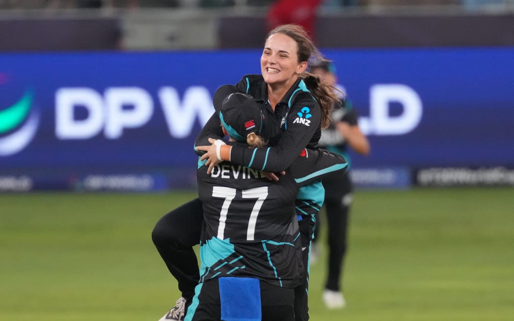 Amelia Kerr leaps into captain Sophie Devine's arms celebrating their World Cup win.