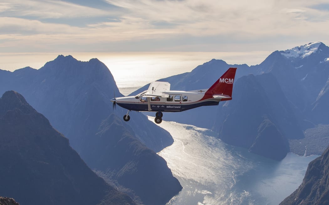 Small Airvan plane over Milford Sound.