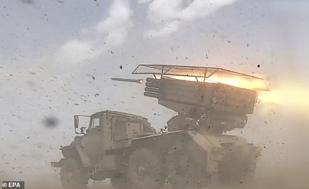 Russian servicemen firing a BM-21 'Grad' self-propelled 122mm multiple rocket launcher system towards Ukrainian positions