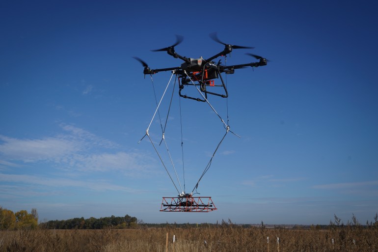 A Ukraine-made Mines Eye drone looks for mines in an agricultural field near front line in the Kharkiv region, Ukraine, Wednesday, Oct. 23, 2024. (AP Photo/Andrii Marienko)