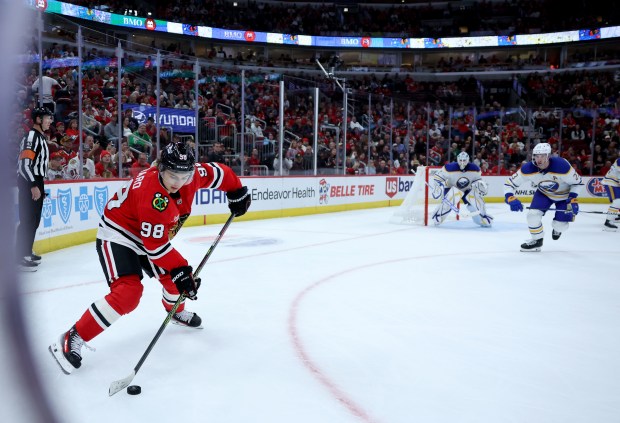 Blackhawks center Connor Bedard looks to pass the puck in the third period against the Sabres at the United Center on Oct. 19, 2024. (Chris Sweda/Chicago Tribune)