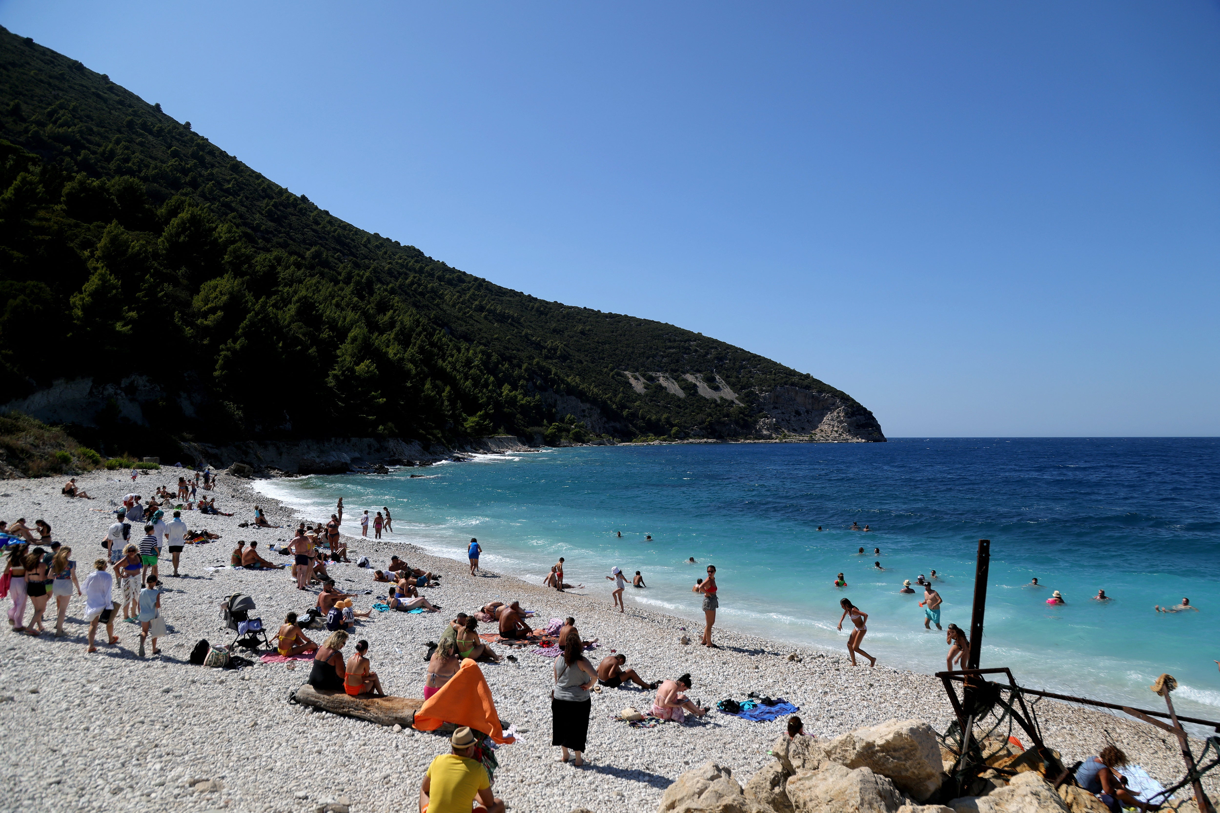 Tourists on a beach on the island of Sazan – the former military base is a half-hour boat ride from Vlore