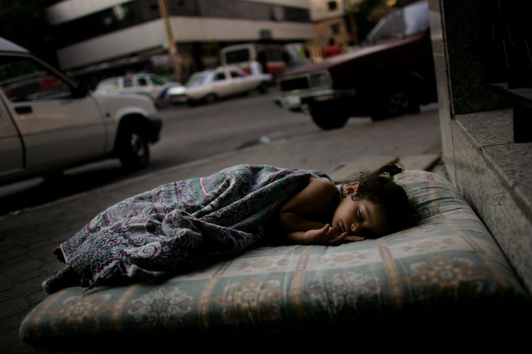 Three-year-old Doua Nabou sleeps on a street corner while waiting for her family to decide where to evacuate to along with hundreds of other residents of Beirut's southern neighborhoods who are evacuating in anticipation of Israeli airstrikes August 10, 2006 in Beirut, Lebanon. After leaflets warning residents to evacuate were dropped by Israeli aircraft Thursday, thousands of people have left the southern districts. At least 41 people were killed with as many as 61 people injured on Monday during an Israeli air strike on a Beirut suburb.