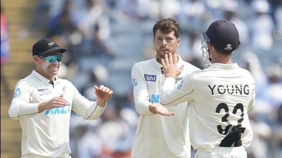 New Zealand's Mitchell Santner celebrates the dismissal of India's Ravichandran Ashwin during the day two of the second cricket Test match in Pune on Friday. (AP)