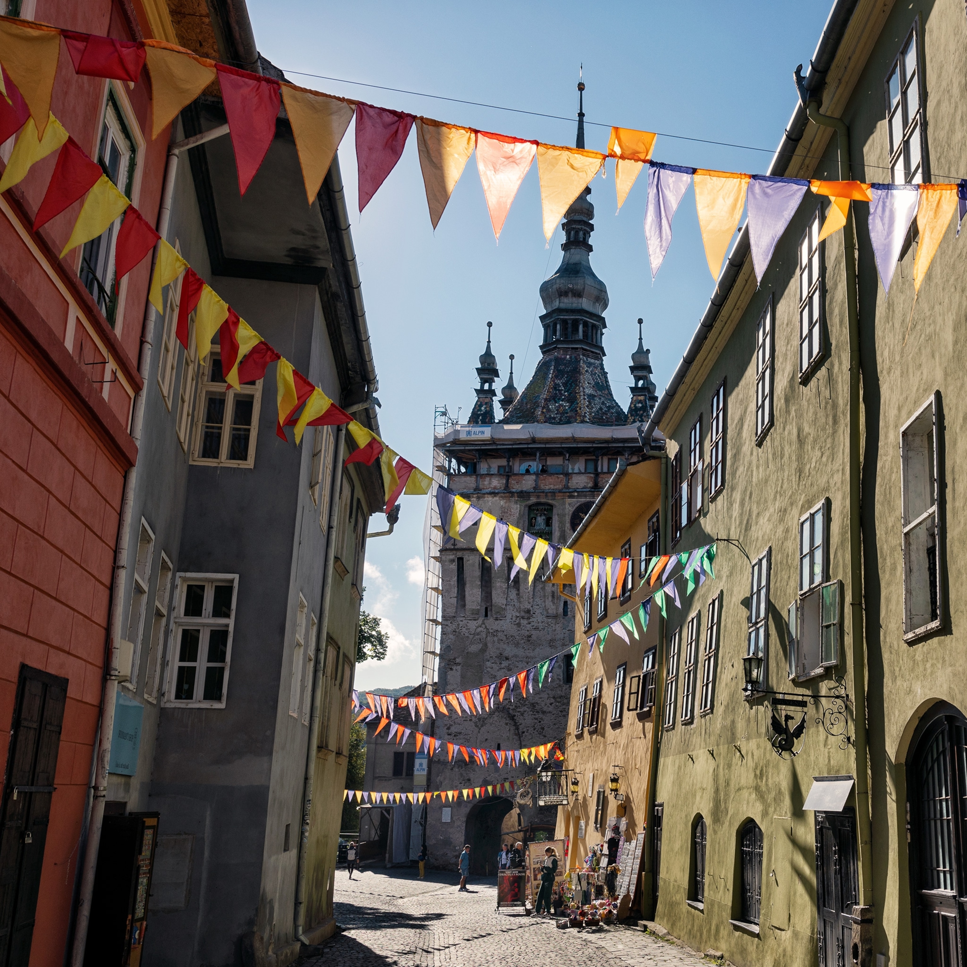 Colorful flags fly above the streets in the historic centre of Sighişoara.