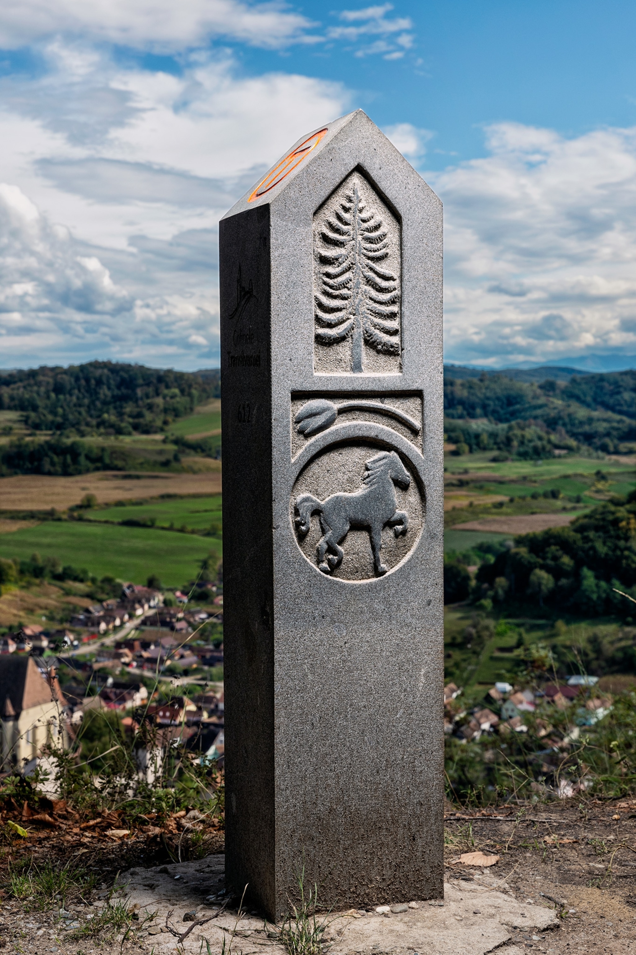 Via Transilvanica in Romania. View of the Biertan village from the Via Transilvanica. In the front a Milestone (marker) of the Via Transilvanica.