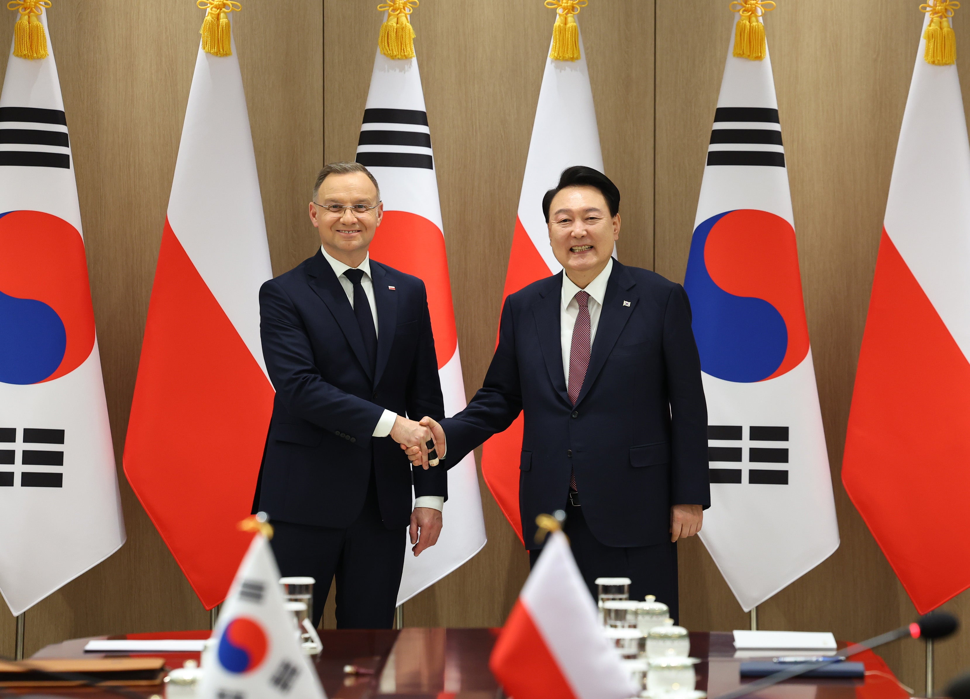 South Korean President Yoon Suk Yeol poses with his Polish counterpart, Andrzej Duda during their talks at the presidential office in Seoul, South Korea