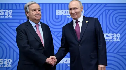 EPA-EFE/REX/Shutterstock UN Secretary General António Guterres (left) shakes hands with Russian President Vladimir Putin in Kazan on 24 October 2024