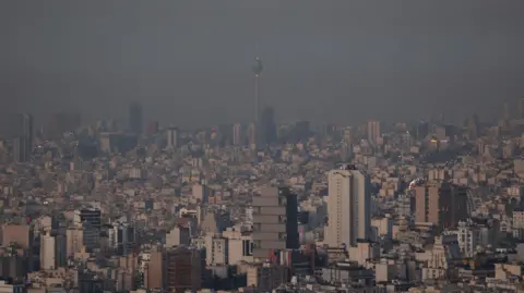 Reuters Hazy skyline picture of Tehran on the morning after the strikes