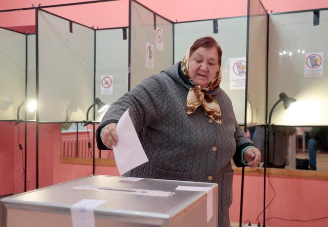 A woman casts her ballot during the second round of parliamentary elections at a polling station in Vilnius, Lithuania, on October 27, 2024.