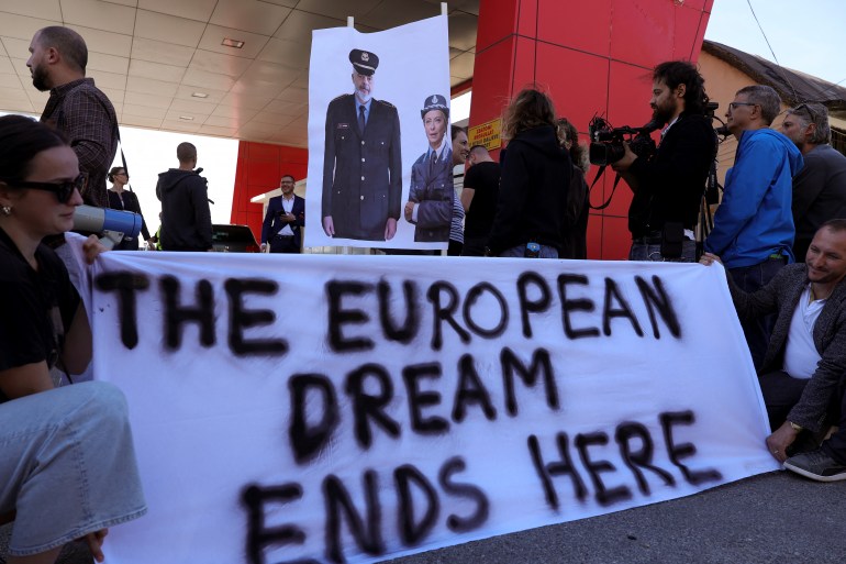 A group of civil rights activists gather in protest, after the first group migrants intercepted in Italian waters, arrived at Shengjin port in Albania on October 16, 2024 [Adnan Beci / AFP]