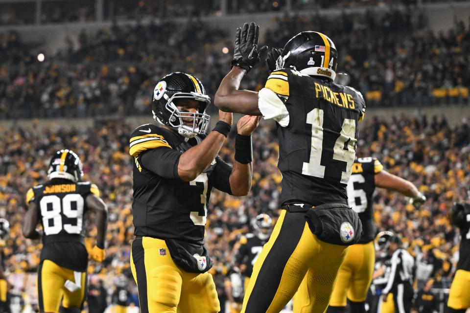 Oct 20, 2024; Pittsburgh, Pennsylvania, USA; Pittsburgh Steelers wide receiver George Pickens (14) celebrates an 11 yard touchdown pass with quarterback Russell Wilson (3) iagainst the New York Jets during the second quarter at Acrisure Stadium. Mandatory Credit: Barry Reeger-Imagn Images