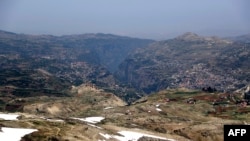 FILE - A picture taken on May 28, 2019, shows the UNESCO World Heritage site of the Qadisha valley, surrounded by the towns of Bcharre (R) and Hasroun, in the Lebanese mountains north of Beirut.