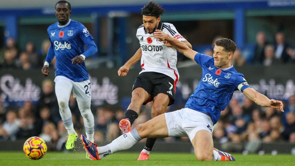 James Tarkowski slides to tackle Raul Jimenez