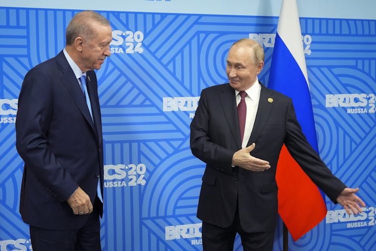 Putin preparing to embrace Turkey's president, Recep Tayyip Erdogan.