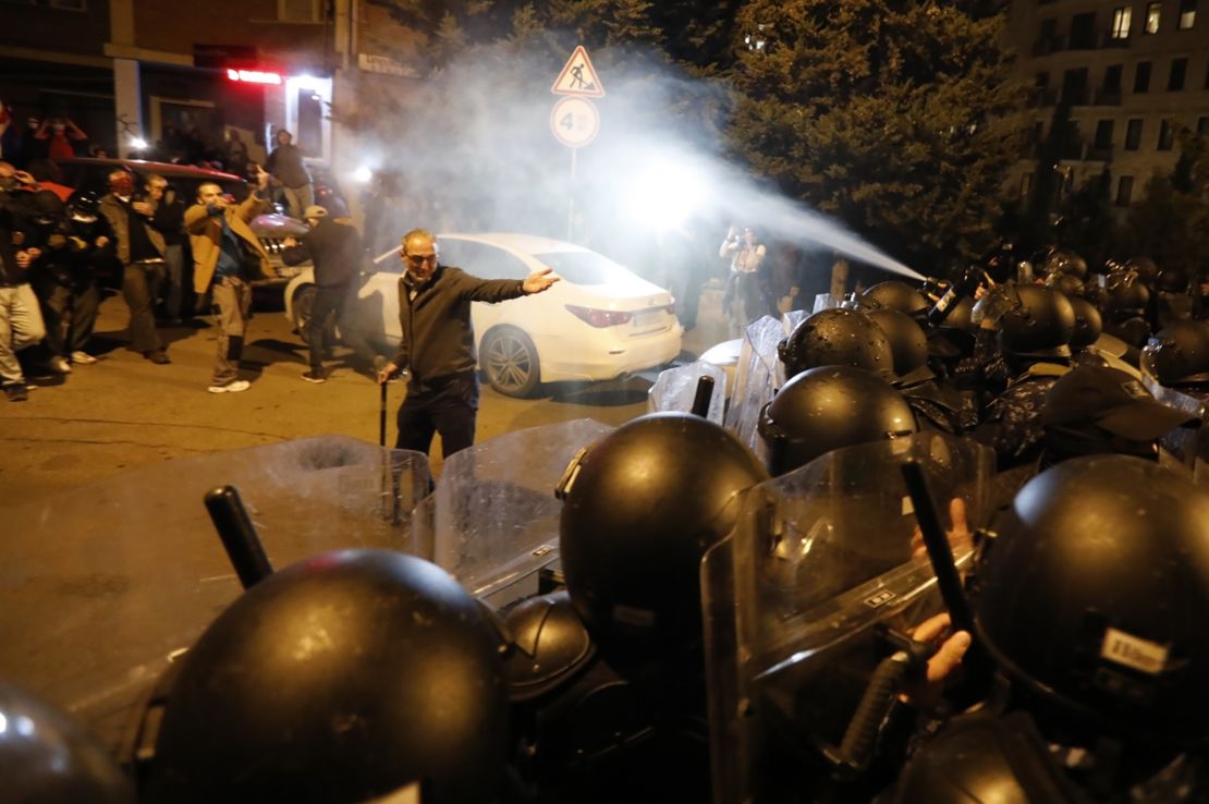 Police spray tear gas at protesters demonstrating against the 