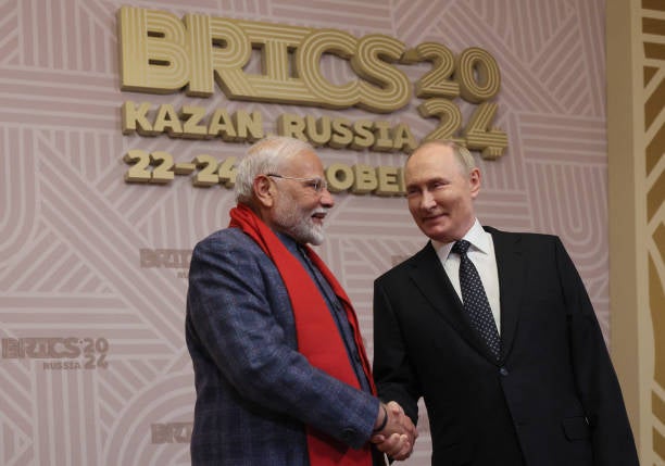 Vladimir Putin greets Narendra Modi during a welcoming ceremony for participants of the Brics summit in Kazan, Russia, 22 October 2024