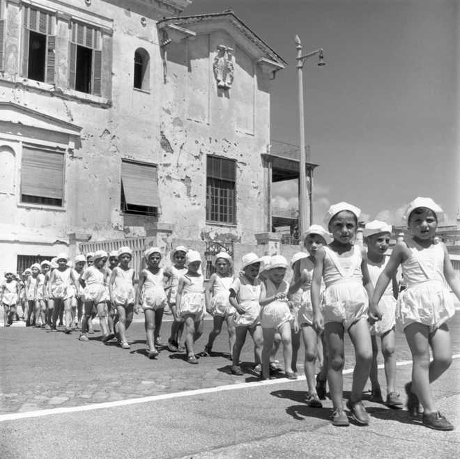 circa 1945:  A group of children walking in line outside a convent in Rome, where they are cared for. Abandoned or orphaned during World War II, the children are known as &apos;The Treasures Of Italy&apos;.  (Photo by Slim Aarons/Getty Images)