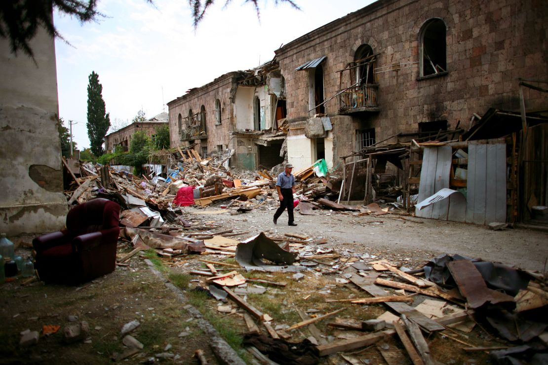 A Georgian man walks past bombed buildings in Gori, Georgia, on August 21, 2008.