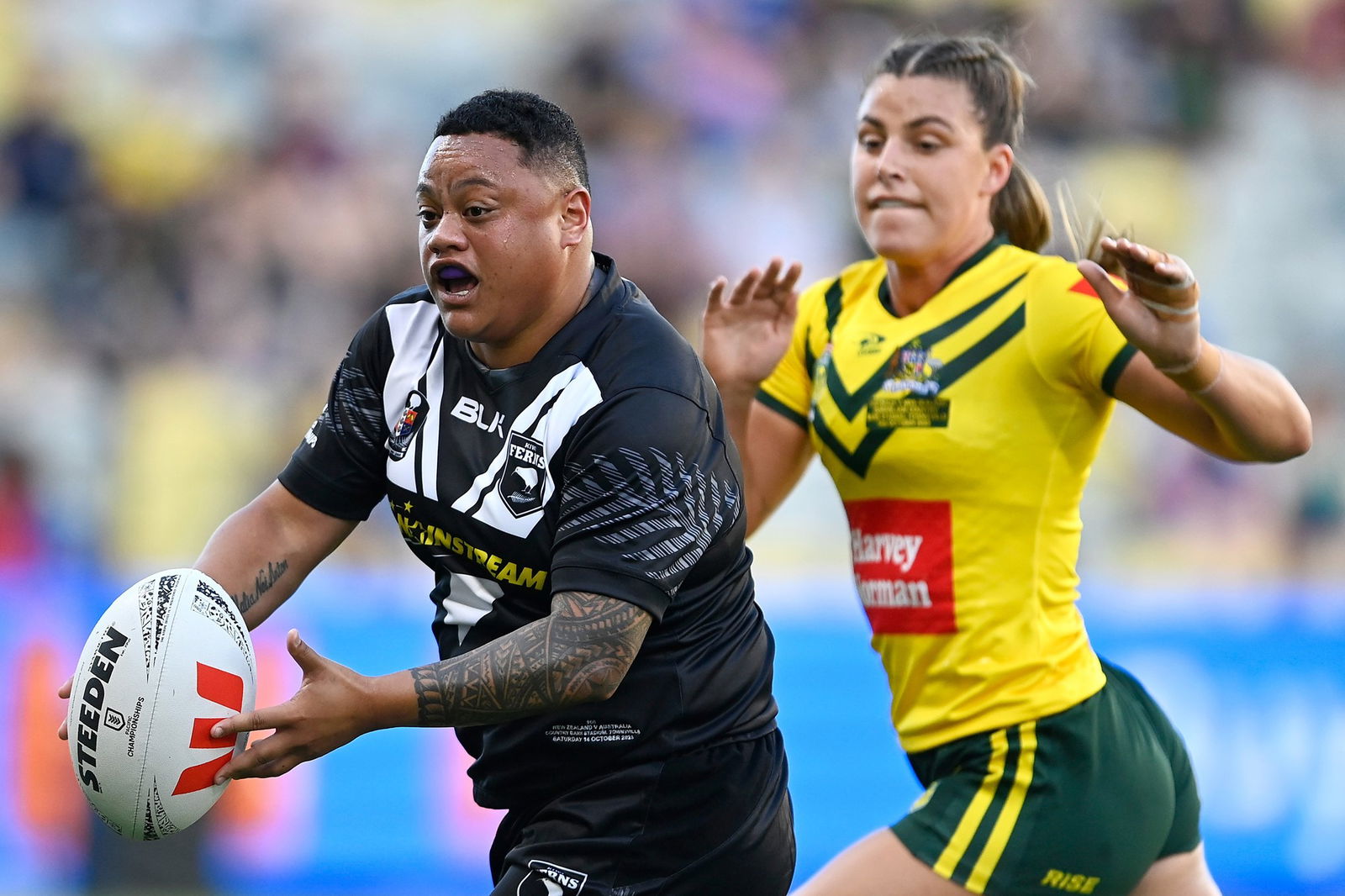 New Zealand rugby league player Mele Hufanga runs away from Australia's Jessica Sergis.