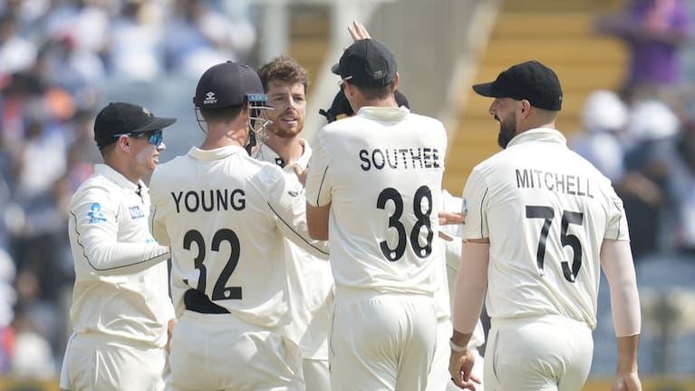 Mitchell Santner, centre, celebrates the dismissal of India's captain Rohit Sharma.