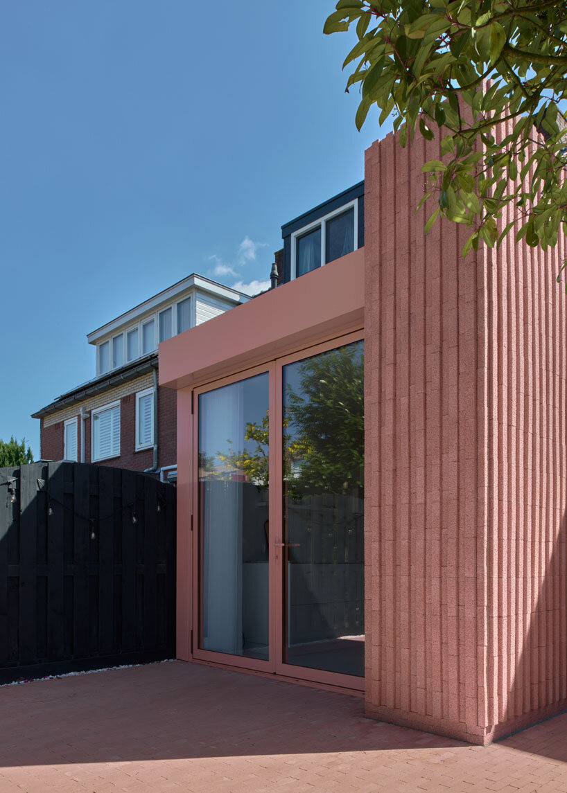 vertical pink concrete bricks wrap atlas architects' rosa home in the netherlands