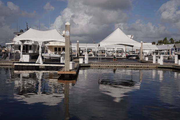 Workers prepare slips at the Bahia Mar Marina in Fort Lauderdale on Tuesday, Oct. 22, 2024, in preparation for the upcoming Fort Lauderdale International Boat Show. The show, which is one of the largest in the world, runs from Oct. 30 to Nov. 3. (Joe Cavaretta/South Florida Sun Sentinel)